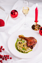 Delicious duck leg served with creamy mashed potatoes and festive decorations for a special occasion