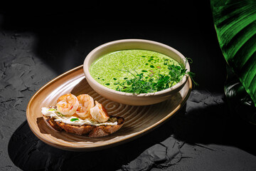 Delicious shrimp toast served with vibrant green soup in an elegant dining setting