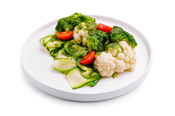 Fresh vegetable medley featuring broccoli, cauliflower, and cherry tomatoes on a white plate