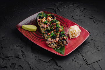 Sliced sushi roll with fresh ingredients served on a decorative plate during a culinary meal