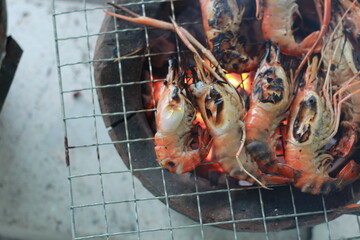  Raw Shrimp on Grill with Charcoal Background