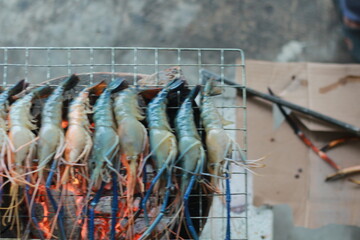  Raw Shrimp on Grill with Charcoal Background