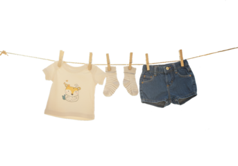 Sweet baby clothes hanging on a clothesline outdoors, including a cute shirt, denim shorts, and socks. Perfect for baby shower announcements or nursery decor