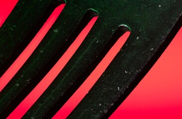 Abstract close up of tines of a fork on red