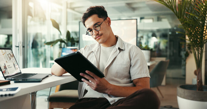 Serious, browsing and man with tablet, office and research for project on social media and content creator. Online, creative and person with website for competition analysis, influencer and planning