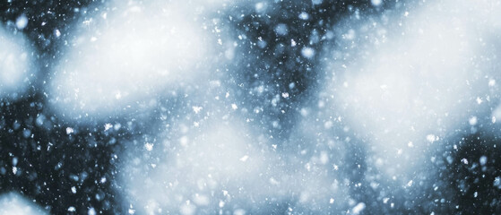 Fresh snowfall blankets the ground on a dark winter night with gentle falling snowflakes