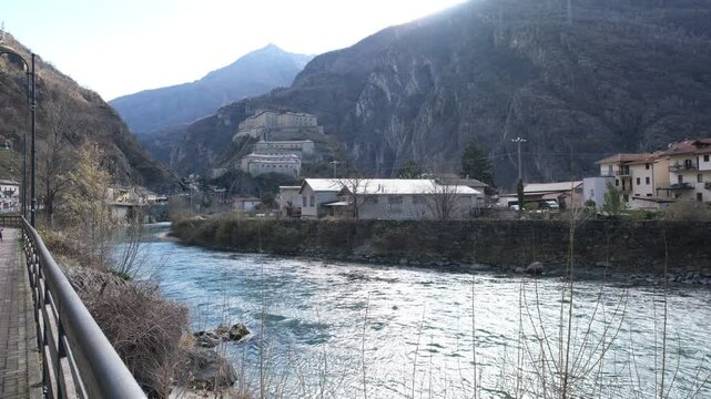 A view of a small village and the Dora Baldea River in the north of the Aoste valley. Bard, Italy 