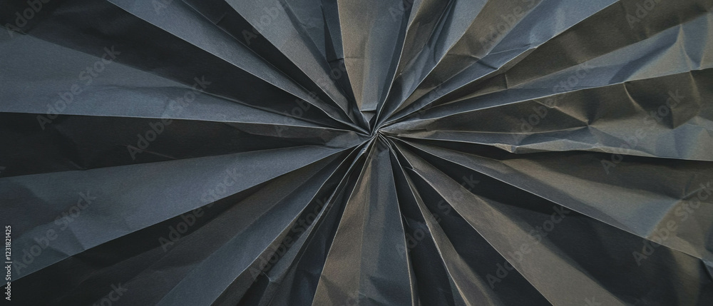 Poster sharp geometric paper folds create dynamic design against a black background