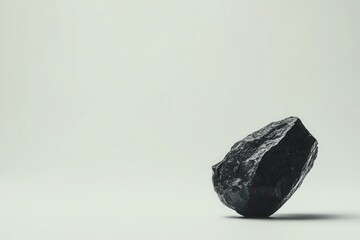 Naklejka premium Black coal rock on neutral background