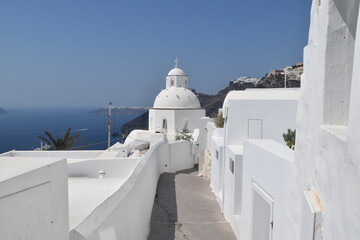 The dramatic steep views over the edge of the volcano crater of Santorini Island overlooking the...
