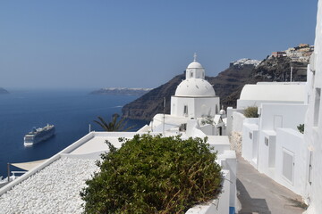 The dramatic steep views over the edge of the volcano crater of Santorini Island overlooking the...