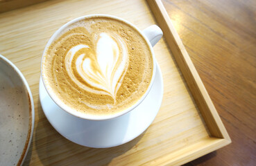 Latte coffee in wooden tray