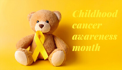 teddy bear with yellow ribbon on yellow background