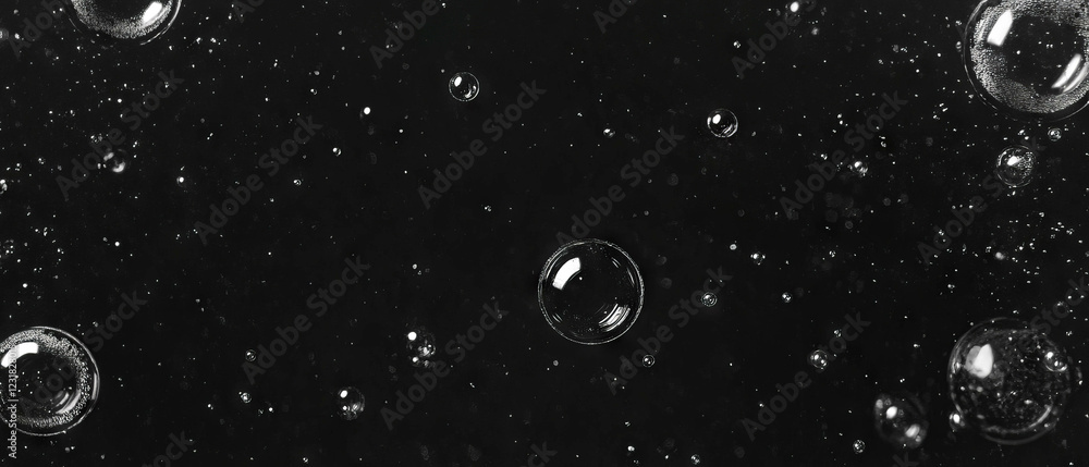 Poster close-up of bubbles showing intricate texture against a black background with macro details