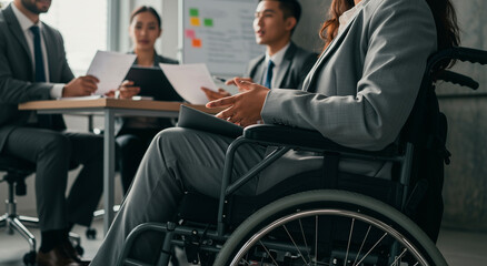 Fototapeta premium Meeting, office and business people with woman in wheelchair, discussion and planning for teamwork. Disability, collaboration and accessibility with employee in conference or workshop.
