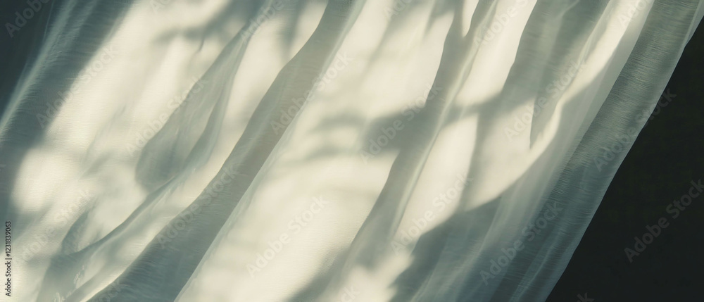 Poster soft curtain shadows create wavy patterns and gentle light against a dark background