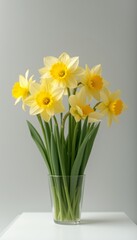 Sophisticated bouquet of yellow flowers arranged in a glass vase