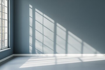Obraz premium Sunlight streams through window onto empty room's blue wall and floor.