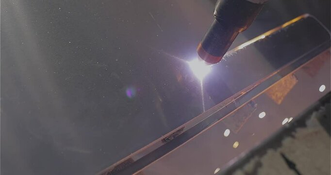 Plasma cutting. Plasma cutter work at the factory. The plasma cutter will cut the part. The process of cutting a metal part with a plasma cutter