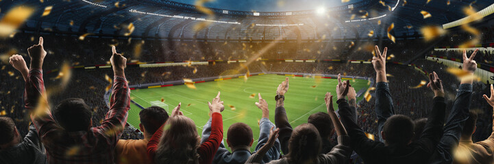 Victory moment. Soccer fans celebrating goal, raising hands up at packed stadium with falling...
