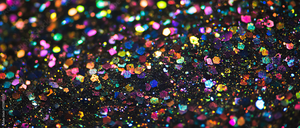 Poster glitter texture with iridescent particles creating vibrant color variations on a dark background
