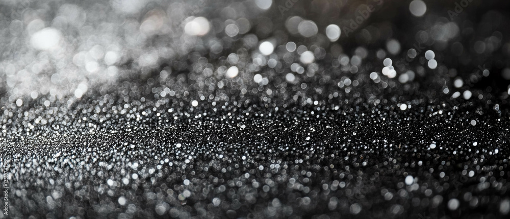 Poster glitter particles create a dreamy bokeh effect on a dark background for an enchanting atmosphere