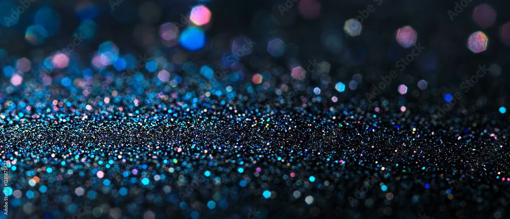 Poster glitter texture with shimmering particles on a black background creates dazzling visual effects