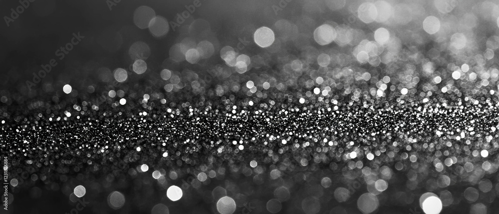 Poster overlay texture of glitter with sparkling particles against a soft black background