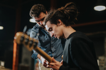 Musicians collaborate during a rehearsal session in a studio environment, focusing on instrument playing techniques and teamwork to prepare for a performance.
