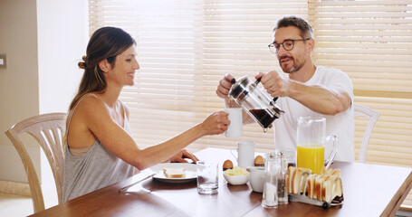 Couple, coffee press and breakfast in morning, home and helping hand with care, love and smile. People, woman and mature man with caffeine, drink and happy together for bonding with food at apartment