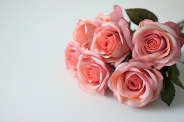 A bouquet of pink roses with soft petals, isolated on a white background with empty space for text.