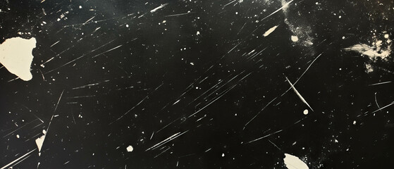 Light scratches and streaks create a textured black background with a worn appearance