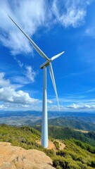 Clean energy generation with wind turbine on hillside under blue sky