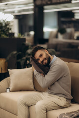Obraz premium A man chooses and buys a pillow and a sofa