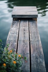 Fototapeta premium A wooden dock extending over a peaceful lake or ocean, suitable for photography, illustrations, and designs