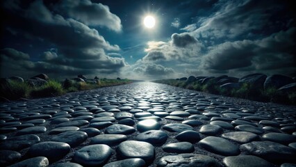 Fototapeta premium Dark, atmospheric night photography captures a mysterious gray stone road, evoking intrigue.
