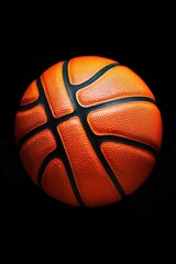 A high-angle view of a basketball on a dark background, ideal for sports-themed designs and marketing materials