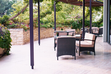 Outdoor Seating Area with Chairs and Tables in a Lush Garden Setting..