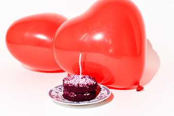 A cake with candle and balloons in shape of heart on background, St.Valentines Day or B-day design