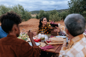 Farmers sharing food and enjoying a meal together in olive grove