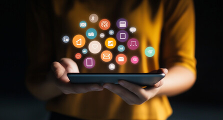 A person holding an iPad with icons of social media and mobile app features floating above it, representing the integration between these digital platforms for online business. 