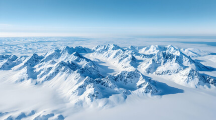 Obraz premium Aerial view of snow-capped mountains, arctic landscape, clear sky, clouds below; ideal for travel brochures