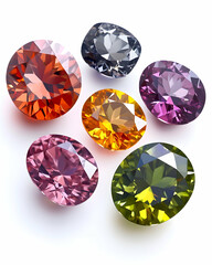 Colorful gemstones arranged on white background; jewelry, gems, precious stones, luxury, sparkling