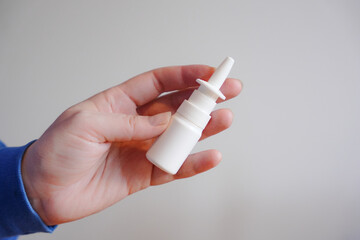 nose sprays, sprays for the nose, nasal spray in hand on a white background