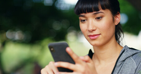 Outdoor, woman and fitness with smartphone for scroll, online exercise and download app for training. Bokeh, female person and browse with mobile for digital video, watch workout tutorial or wellness