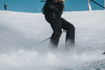 A skier is navigating a snowy slope, creating a cloud of snow with dynamic action.