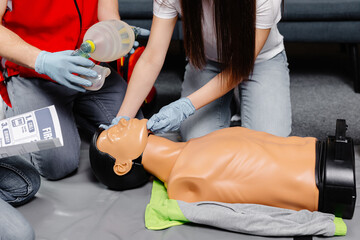 Woman holding breathing bag Ambu bag.Demonstrating CPR Cardiopulmonary resuscitation training...