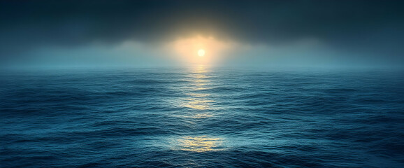 Obraz premium Moody Sunrise over Foggy Ocean: Dark Blue Water Reflecting Golden Light