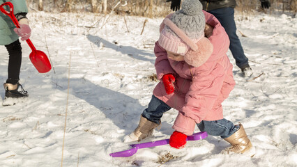Playful family enjoying snowball fight in snowy winter park