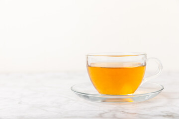 Cup of hot ginger tea with slices of ginger root on wooden background. Warming drink. Alternative medicine. Tea with honey, lemon, ginger and mint. Space for text. Copy space